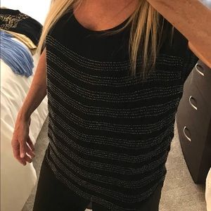 Joie top with grey beads stitched on a shear black fabric, lined.